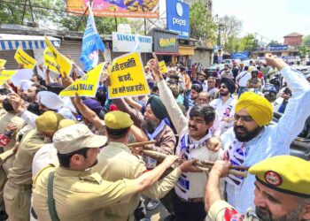 Police stop Aam Aadmi Party supporters during a protest against PDP and BJP, in Jammu.